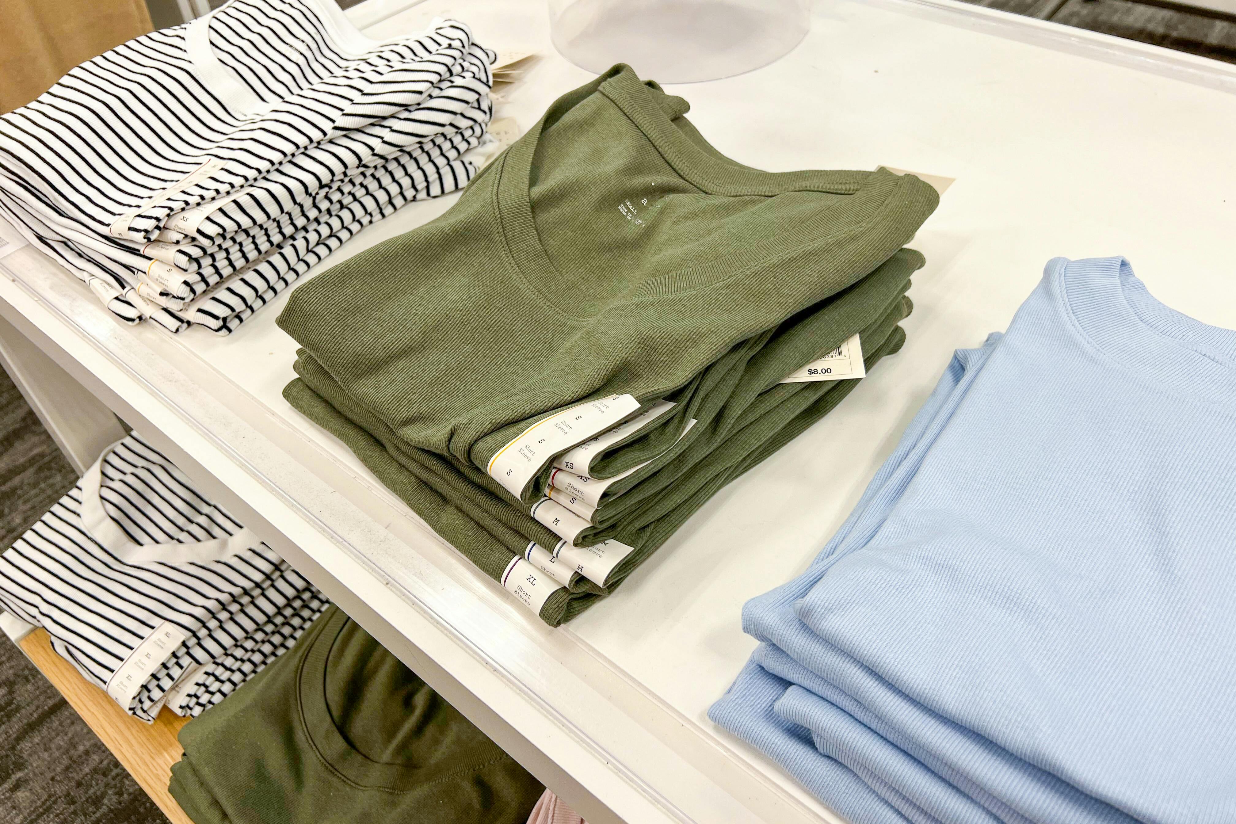 Folded women's tops on display in Target store
