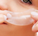 a person putting on under-eye patches