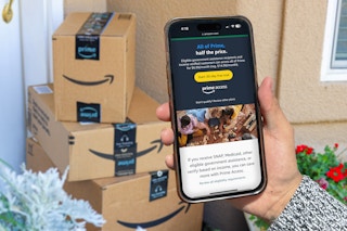 someone looking at an amazon access page outside their door with amazon packages