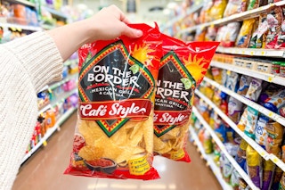 hand holding bags of on the border chips