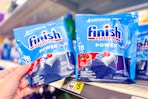 hand grabbing a bag of finish dish tabs