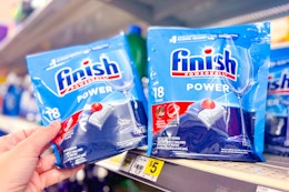 hand grabbing a bag of finish dish tabs