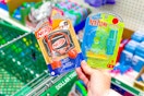 hand holding micro games nerf and kerplunk above dollar tree shopping cart