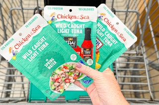 hand holding chicken of the sea tuna pouches