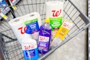 toilet paper, paper towels, trash bags, and cleaning supplies in a cart