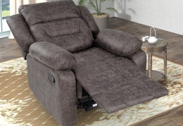 A gray suede-like oversized recliner in the recline position