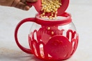 kernels being poured into a popcorn popper