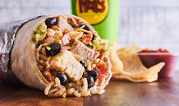 A Moe's Southwest grill burrito, chips, salsa, and a drink