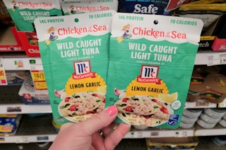hand holding chicken of the sea tuna pouches