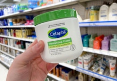 hand holding cetaphil cream