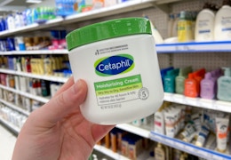 hand holding cetaphil cream