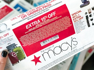Someone holding up a coupon for Macy's