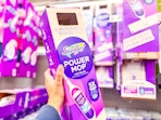Swiffer Powermop Kit held up in Walmart store aisle (sponsored)