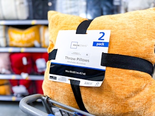 the yellow mustard colored Mainstays throw pillows in a WAlmart Cart