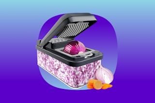 A vegetable chopper with interchangeable blades on the top and a shoe box size receptacle for chopped veg