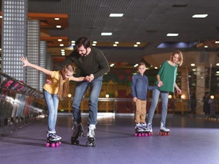 children and their parents rollerskating
