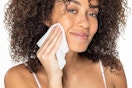 Woman using makeup removing wipe. B07GKVBQDG