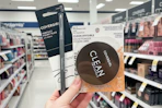 person holding covergirl eyeliner and setting powder in an aisle