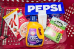 special k cereal, pepsi soda, native body wash, black forest gummies, and arm & hammer detergent in a cart