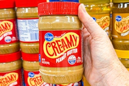 hand holding a jar of kroger peanut butter