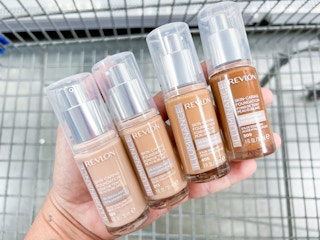 hand holding multiple shades of Revlon Illuminance foundation