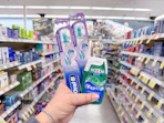 hand holding crest and oral-b items in walgreens