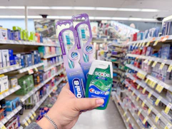 hand holding crest and oral-b items in walgreens