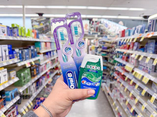 hand holding crest and oral-b items in walgreens