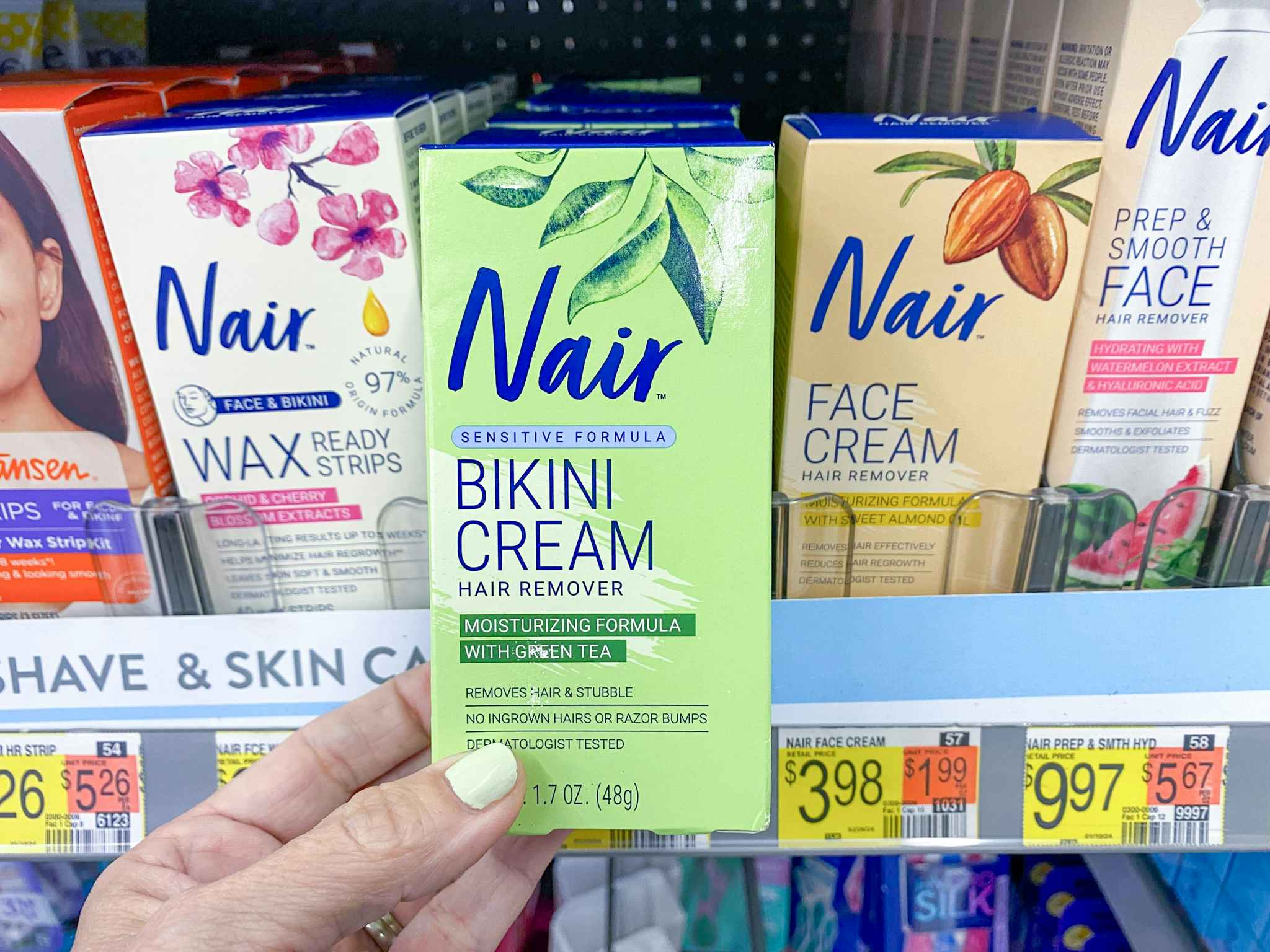person holding a box of nair bikini cream