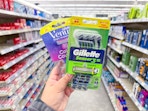 hand holding gillette and venus disposable razors in walgreens