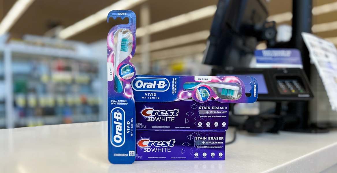 crest 3d white stain eraser toothpaste and oral-b vivid whitening toothbrush on a checkout counter