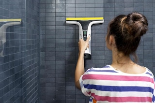 a woman using an electric squeegee
