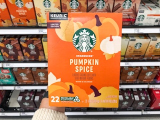 hand holding box of k-cups in front of Target store shelf