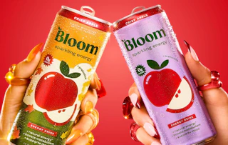 two hands holding energy drinks