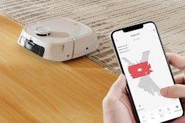 Person linking phone to Vacmop