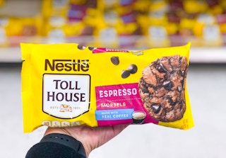 hand holding bag of chocolate chips in front of baking aisle at Target