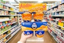 hand holding kraft and velveeta cups