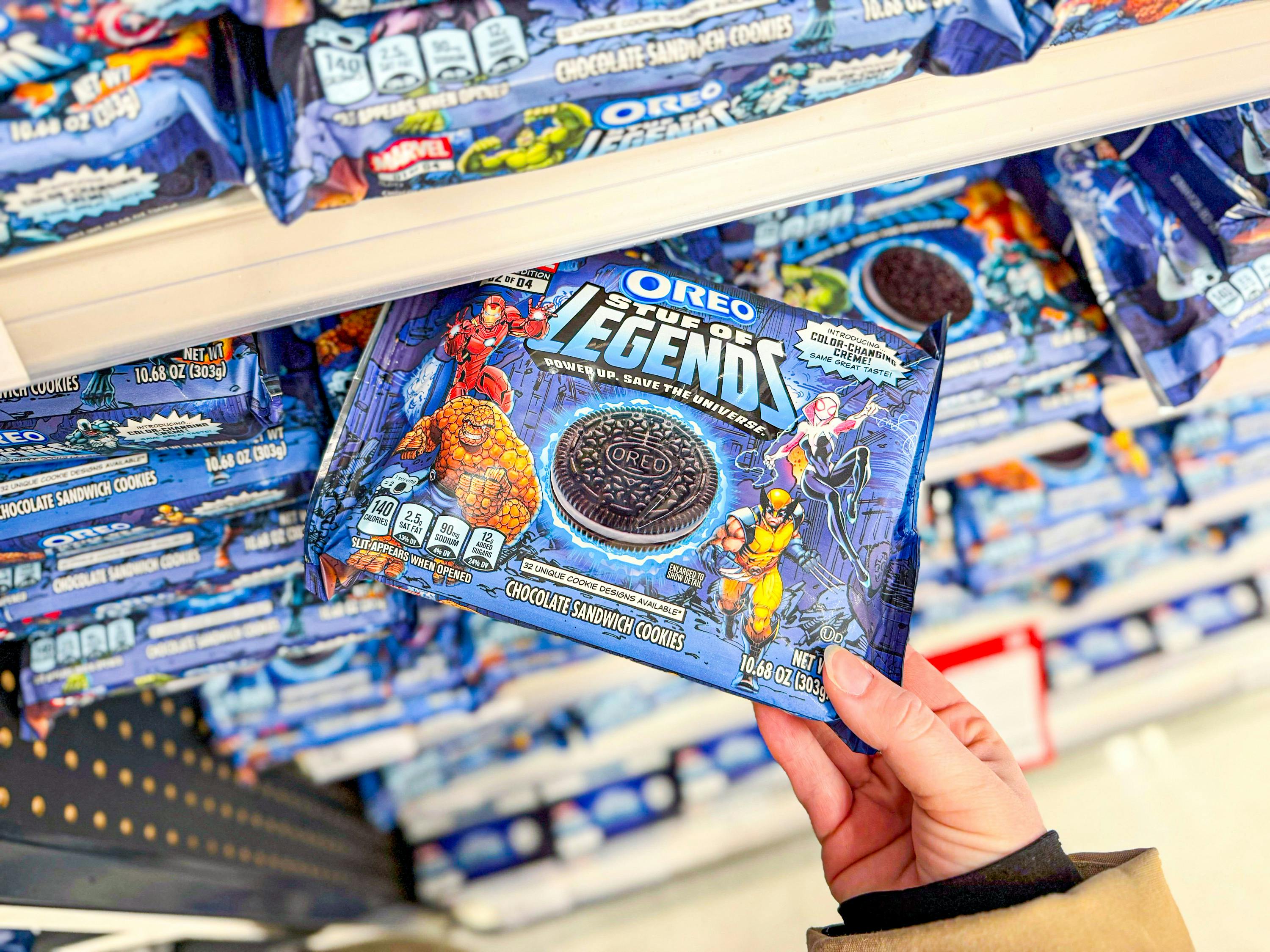 hand grabbing marvel oreo cookies off a target shelf