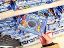 hand grabbing marvel oreo cookies off a target shelf