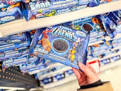 hand grabbing marvel oreo cookies off a target shelf