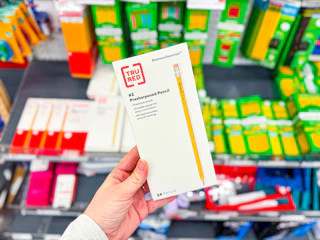 hand holding tru red pencils in staples