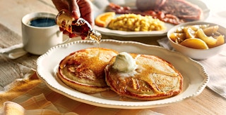 person pouring syrup on cracker barrel grandmas pancakes feature