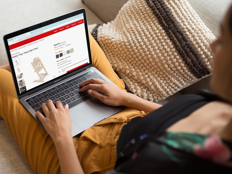 person on laptop shopping at target site for stokke high chair