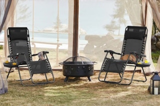 two anti gravity chairs by a fire pit