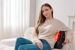 Woman using the KNQZE 3-in-1 Shiatsu Back Massager.