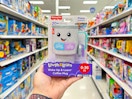 hand holding fisher price coffee mug in aisle