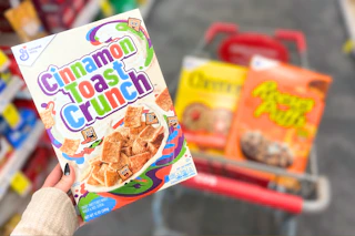 hand holding a box of cinnamon toast crunch cereal