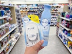 hand holding febreze plug in and air freshener in walgreens
