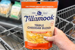 hand holding a bag of tillamook cheese