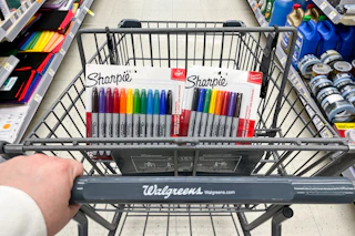 hand pushing shopping cart with sharpies